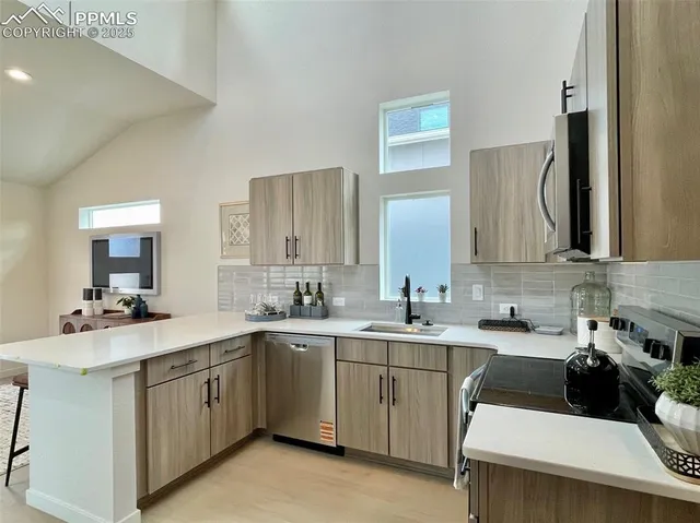 a kitchen with stainless steel appliances a refrigerator and a stove top oven