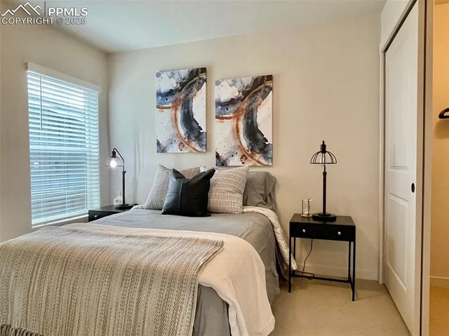 a bedroom with a bed and a lamp