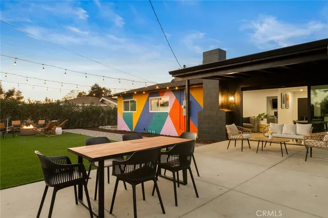a backyard of a house with table and chairs