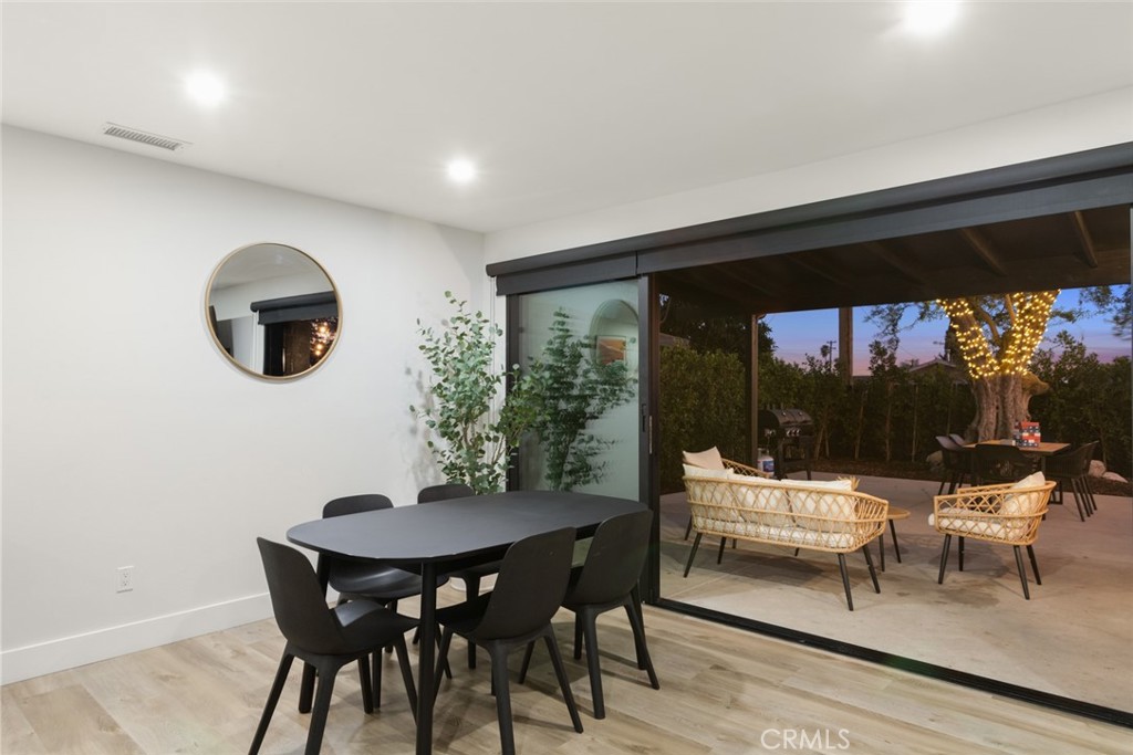 4555 Oakdale Street Montclair, CA 91763 - Photo 2 of 39 a living room with a table and chairs and a potted plant