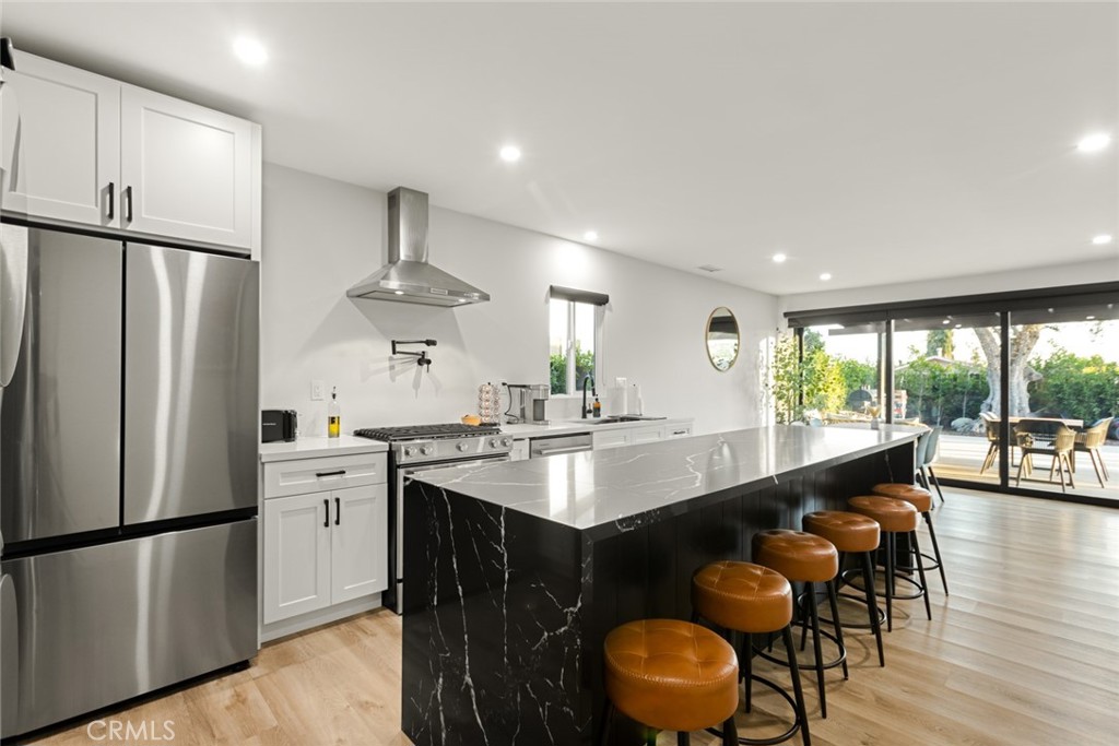 4555 Oakdale Street Montclair, CA 91763 - Photo 22 of 39 a kitchen with stainless steel appliances granite countertop a sink stove and refrigerator