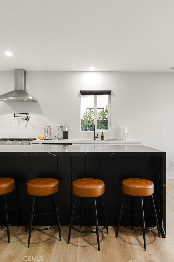 4555 Oakdale Street Montclair, CA 91763 - Photo 23 of 39 a kitchen with stainless steel appliances a table chairs and a refrigerator