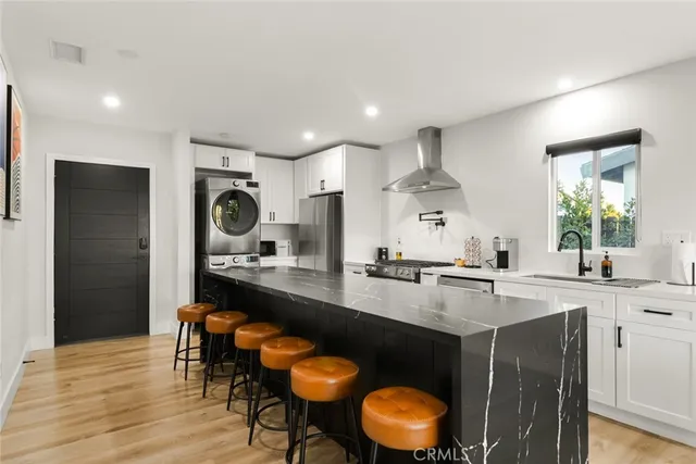 a kitchen with stainless steel appliances granite countertop a sink and a stove