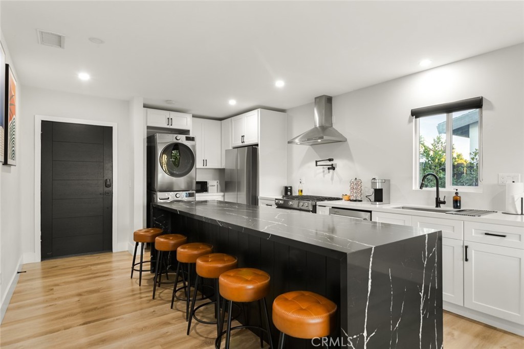 4555 Oakdale Street Montclair, CA 91763 - Photo 24 of 39 a kitchen with stainless steel appliances granite countertop a sink a stove a refrigerator cabinets and dining table