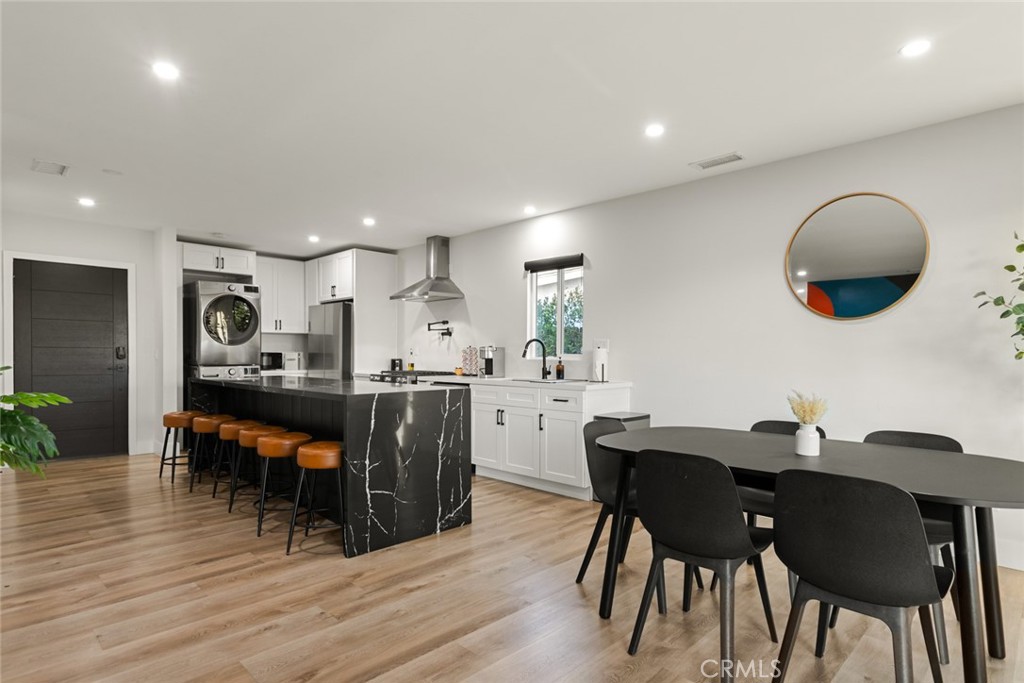 4555 Oakdale Street Montclair, CA 91763 - Photo 27 of 39 a kitchen with a dining table chairs and wooden floor
