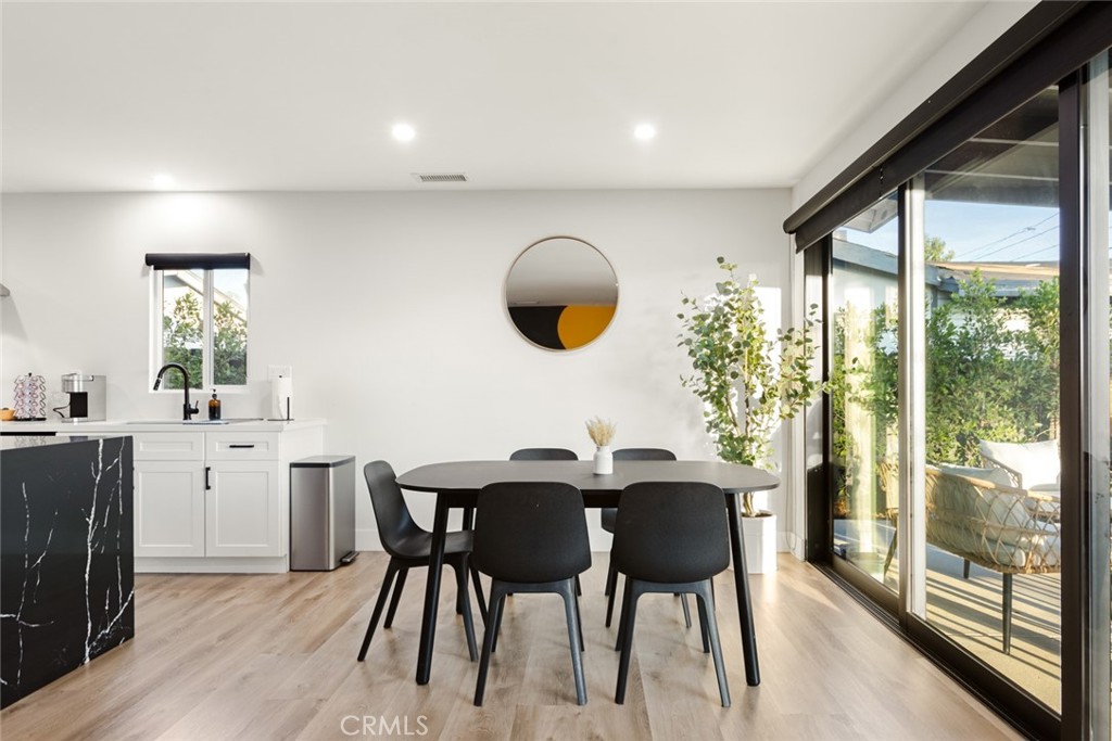 4555 Oakdale Street Montclair, CA 91763 - Photo 28 of 39 a kitchen with a table chairs and wooden floor