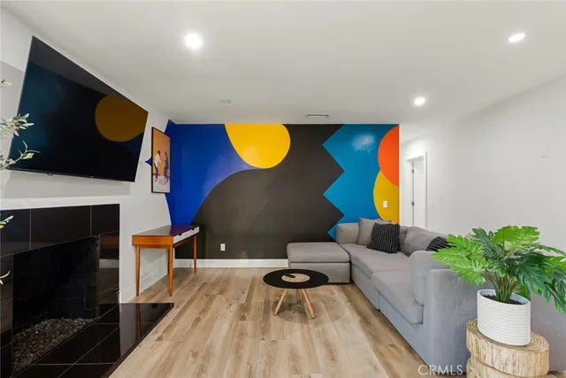 a living room with furniture a fireplace and a flat screen tv