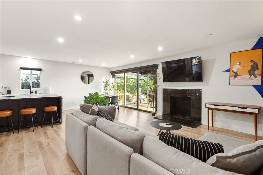 4555 Oakdale Street Montclair, CA 91763 - Photo 31 of 39 a living room with furniture a fireplace and a flat screen tv