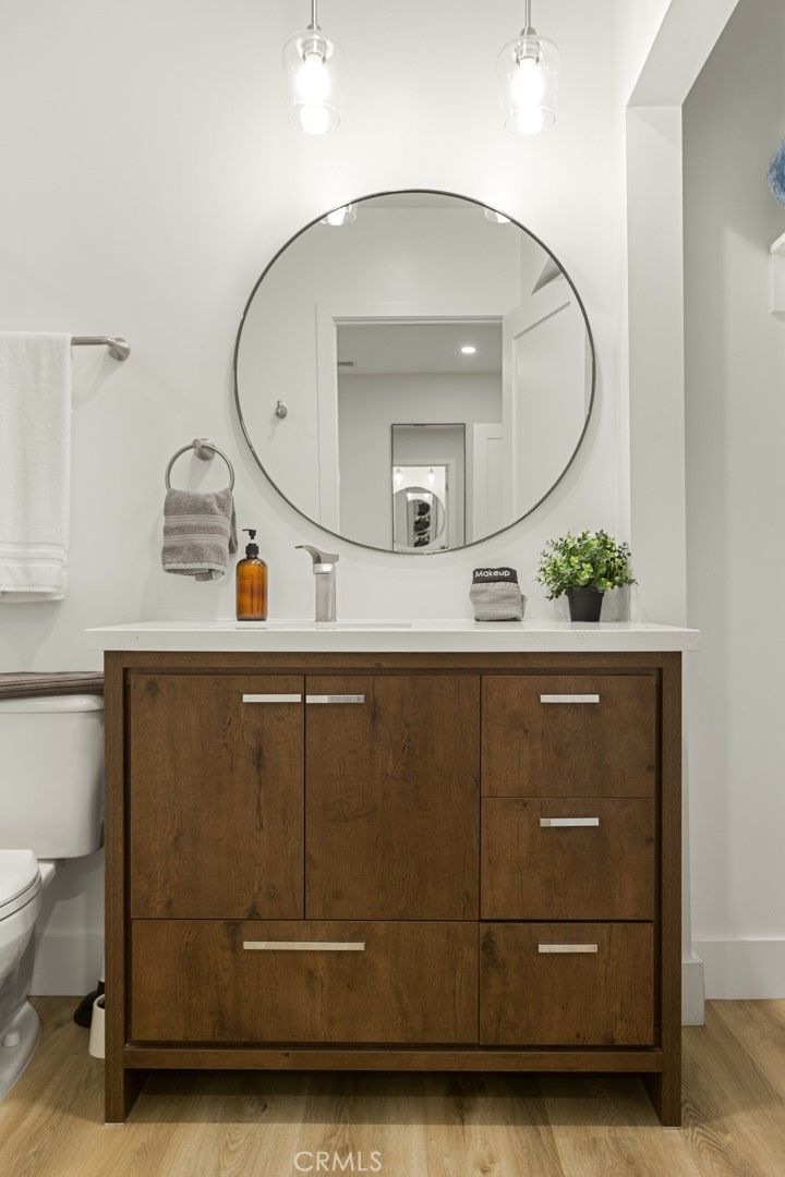 4555 Oakdale Street Montclair, CA 91763 - Photo 32 of 39 a bathroom with a sink a mirror and vanity