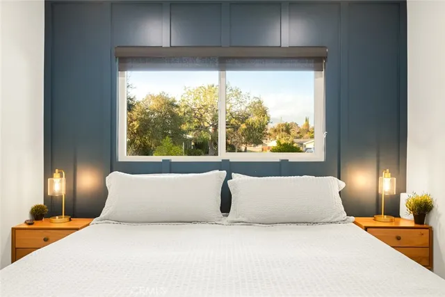 a bedroom with a large bed and a window