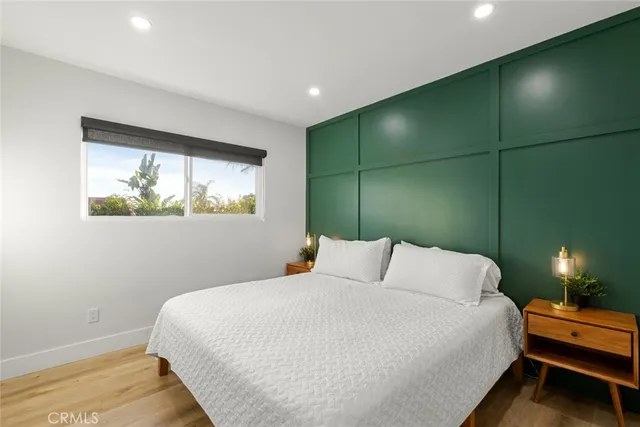 a bedroom with a bed lamps and a chandelier
