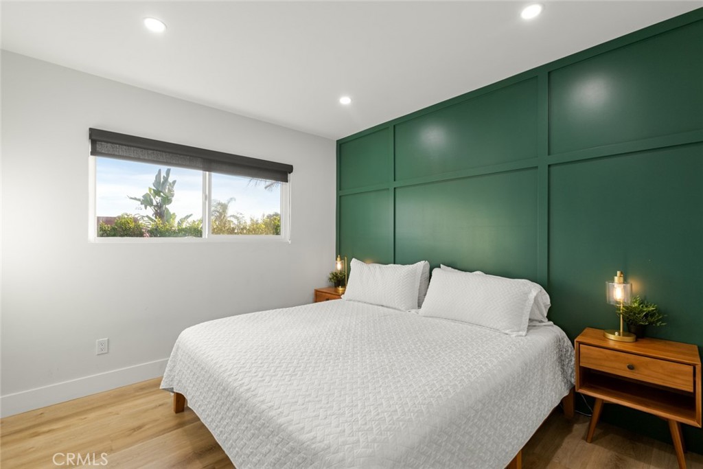 4555 Oakdale Street Montclair, CA 91763 - Photo 38 of 39 a bedroom with a bed and a lamp next to a window