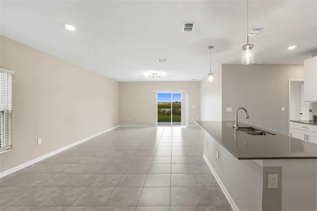a view of a kitchen with a sink and a refrigerator