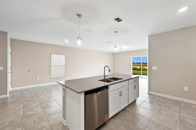 a kitchen that has a sink and a stove