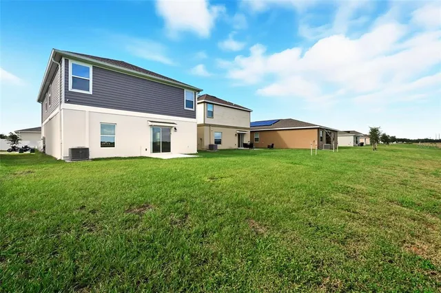 a view of a sign board with buildings in the background