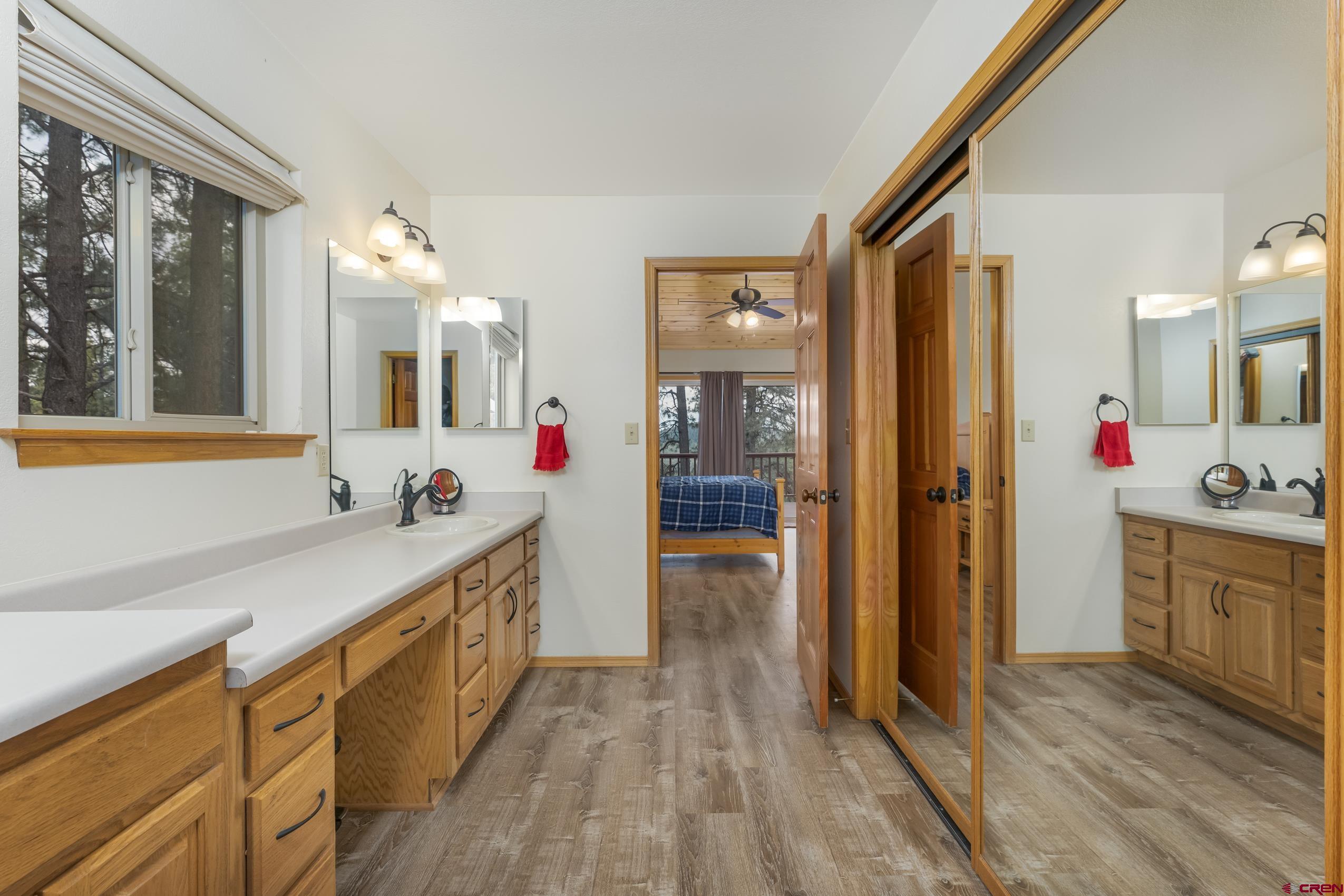 197 Buckhorn Road Bayfield, CO 81122 - Photo 19 of 34 a spacious bathroom with a sink mirror and shower