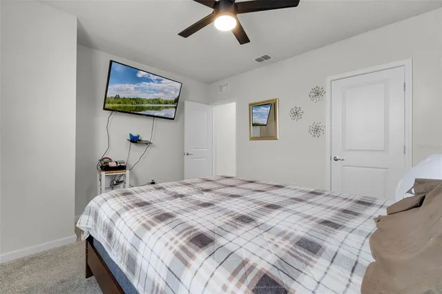 a bedroom that has a bed and painting on the wall