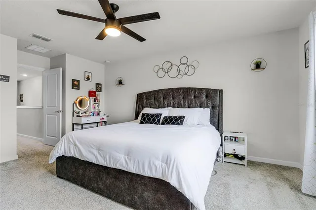 a bedroom with a bed and a book shelf