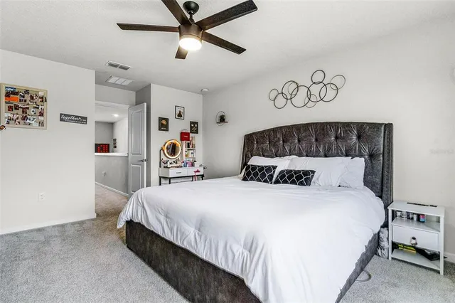 a bedroom with a bed and a large mirror