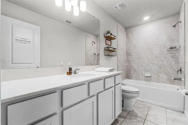 a bathroom with a sink a toilet and bathtub