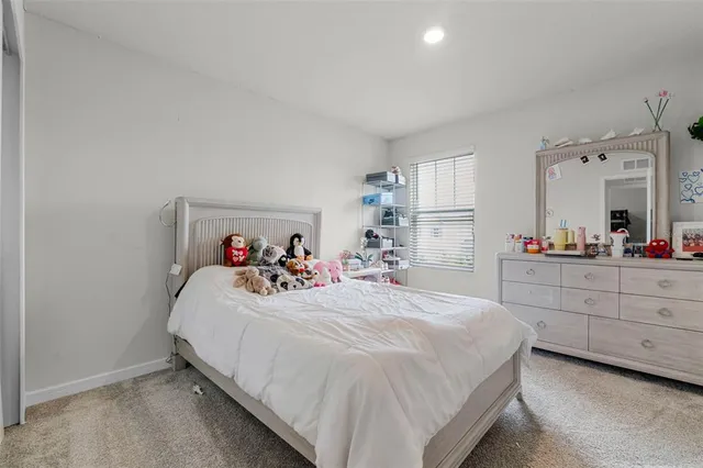 a bedroom with a bed and a dresser