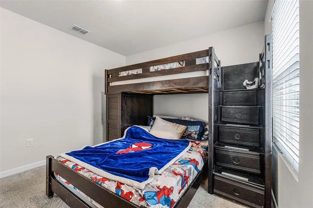 a bed room with a bed and a window