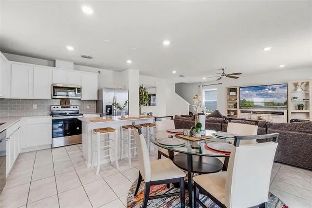 a large kitchen with a table and chairs