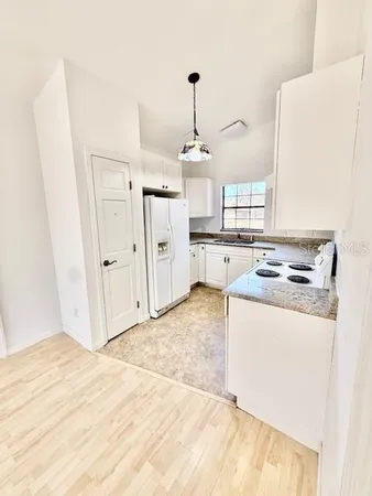 a kitchen with stainless steel appliances a stove a refrigerator and cabinets
