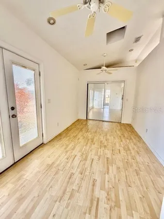 a view of empty room with wooden floor