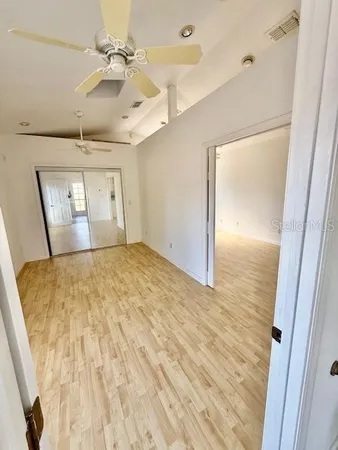 a view of empty room with wooden floor
