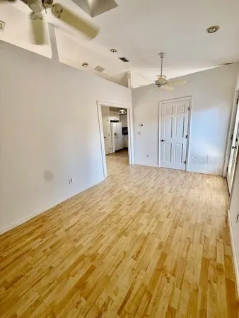 a bathroom with a granite countertop sink a toilet and a window
