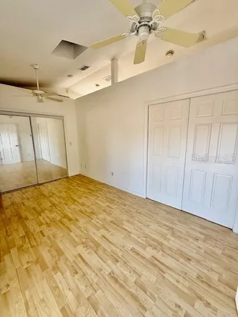 a kitchen with granite countertop a stove a sink and a refrigerator