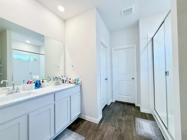 a bathroom with a glass shower door