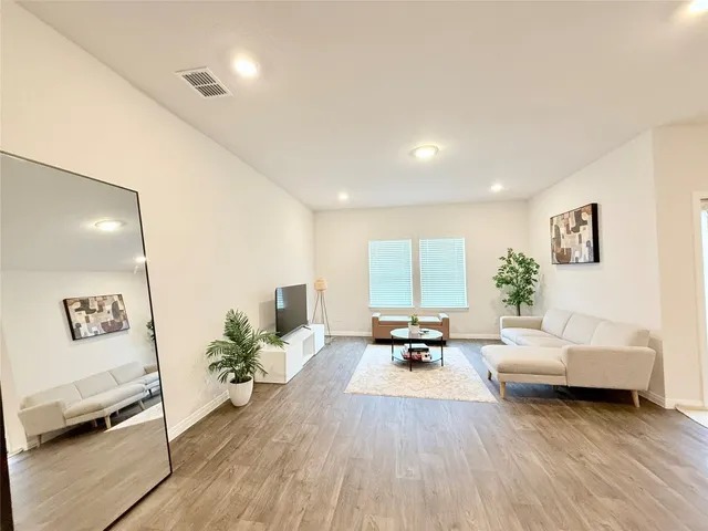 a living room with furniture and a potted plant