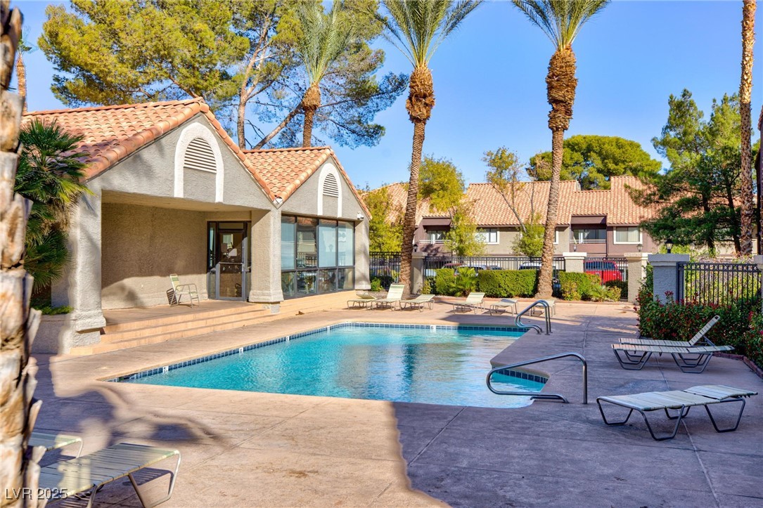 Community pool with a patio