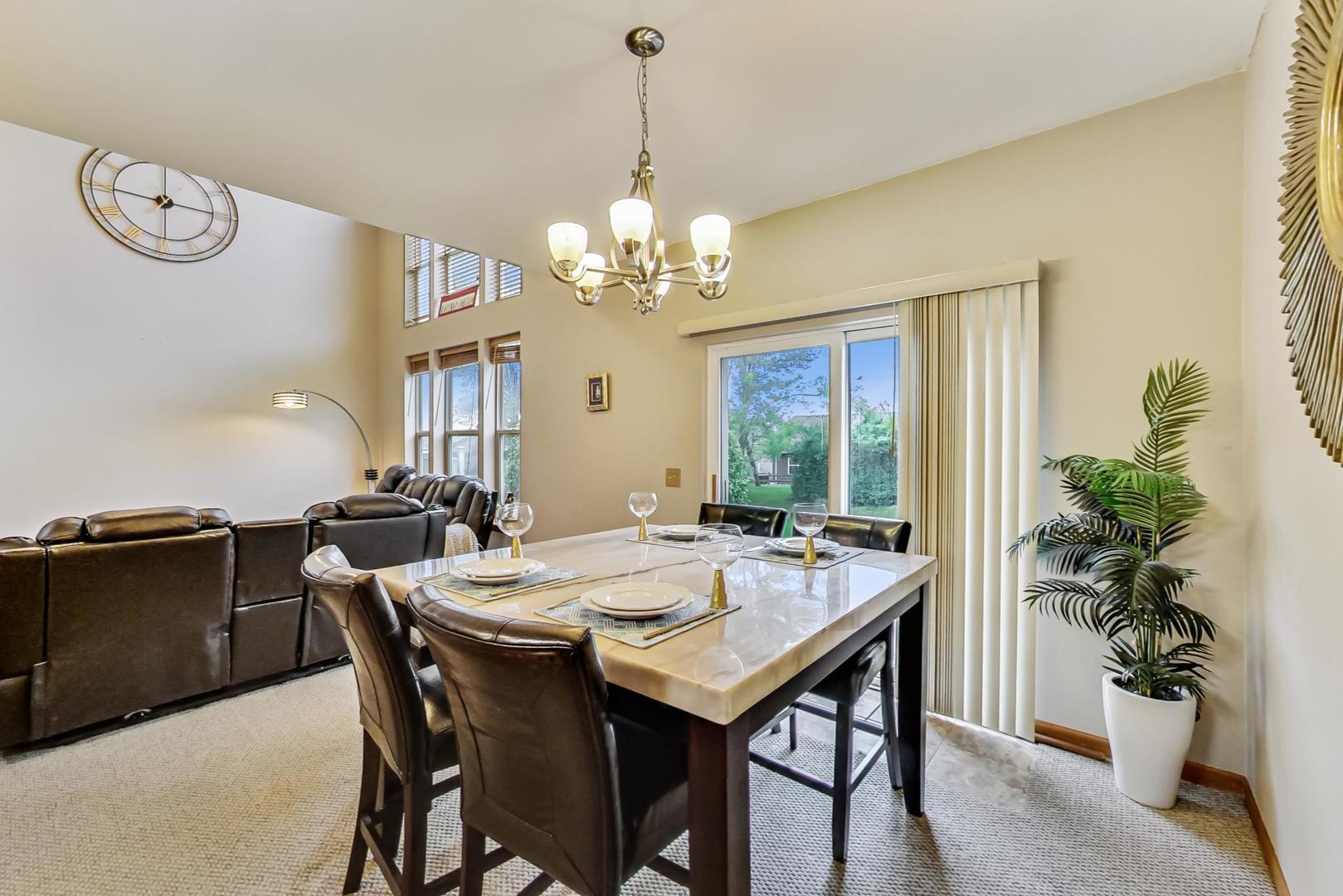 345 Ridge Road North Aurora, IL 60542 - Photo 8 of 38 a view of a dining room with furniture window and wooden floor