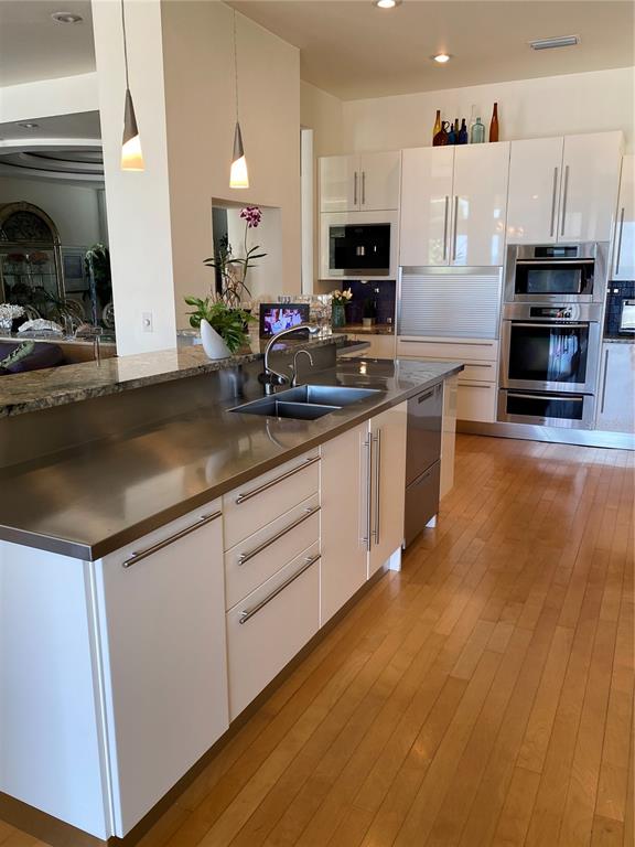 1522 Gulf Boulevard Indian Rocks Beach, FL 33785 - Photo 20 of 52 a kitchen with kitchen island granite countertop a stove top oven a sink a counter space and cabinets