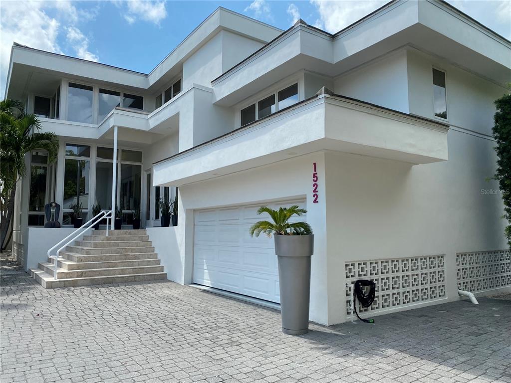 1522 Gulf Boulevard Indian Rocks Beach, FL 33785 - Photo 2 of 52 a view of a brick house with potted plants