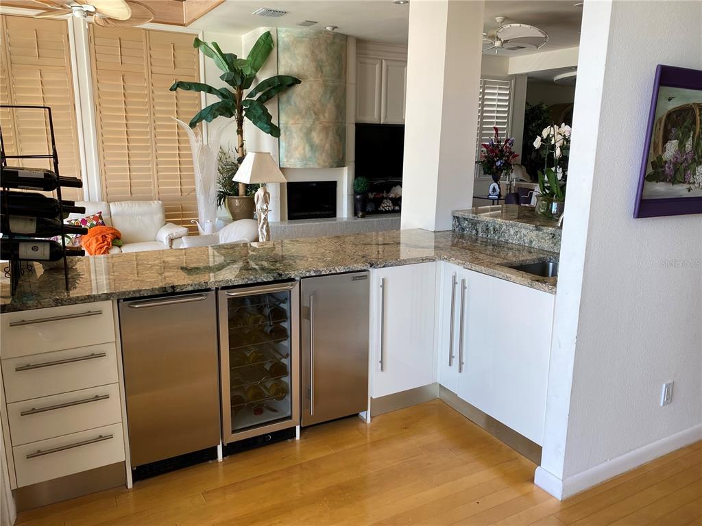 1522 Gulf Boulevard Indian Rocks Beach, FL 33785 - Photo 23 of 52 a kitchen with stainless steel appliances granite countertop a sink and a refrigerator
