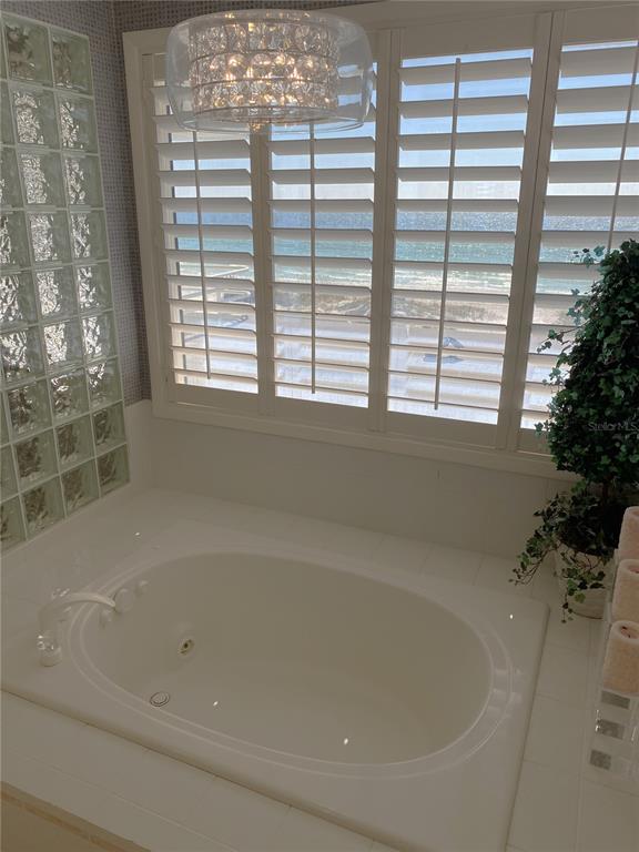 1522 Gulf Boulevard Indian Rocks Beach, FL 33785 - Photo 39 of 52 a bathroom with bathtub and window