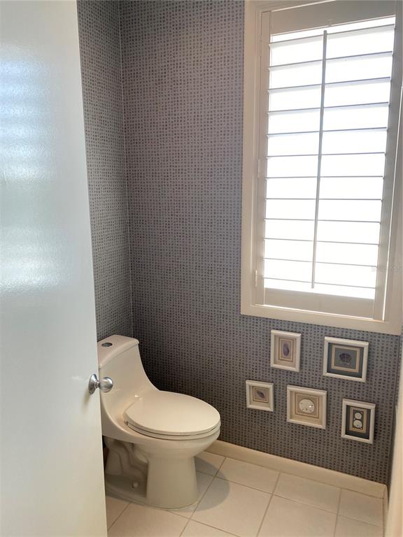 1522 Gulf Boulevard Indian Rocks Beach, FL 33785 - Photo 41 of 52 a white toilet sitting next to a window