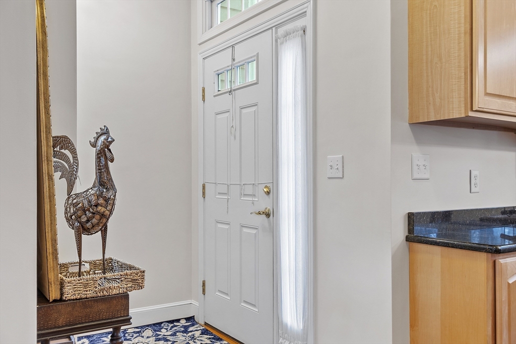 820 Main Street, Unit 1 Wakefield, MA 01880 - Photo 11 of 36 a bathroom with a granite countertop sink and a mirror