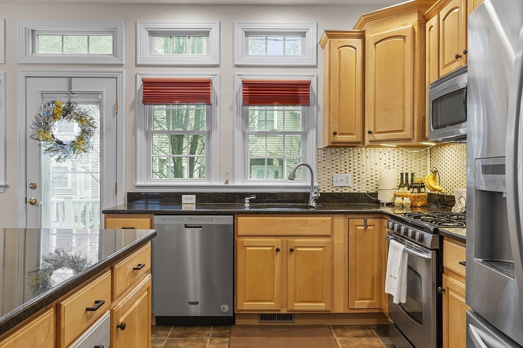 820 Main Street, Unit 1 Wakefield, MA 01880 - Photo 15 of 36 a kitchen with stainless steel appliances granite countertop a stove and a sink