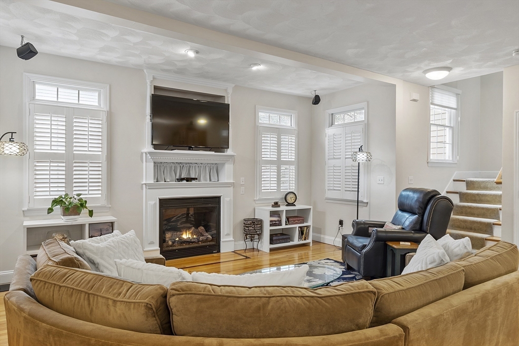 820 Main Street, Unit 1 Wakefield, MA 01880 - Photo 19 of 36 a living room with furniture and a fireplace