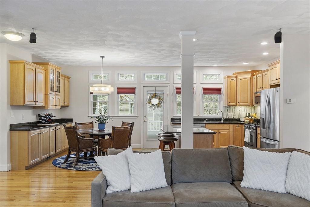 820 Main Street, Unit 1 Wakefield, MA 01880 - Photo 21 of 36 a living room with furniture kitchen area and a chandelier