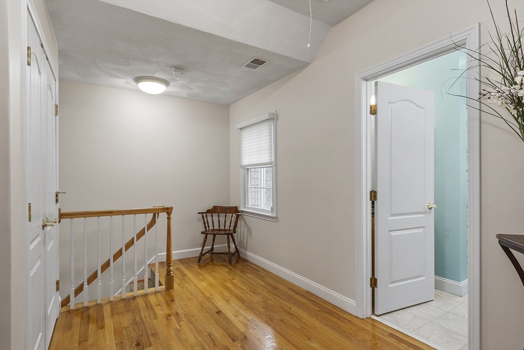 820 Main Street, Unit 1 Wakefield, MA 01880 - Photo 25 of 36 a view of a hallway with wooden floor and staircase