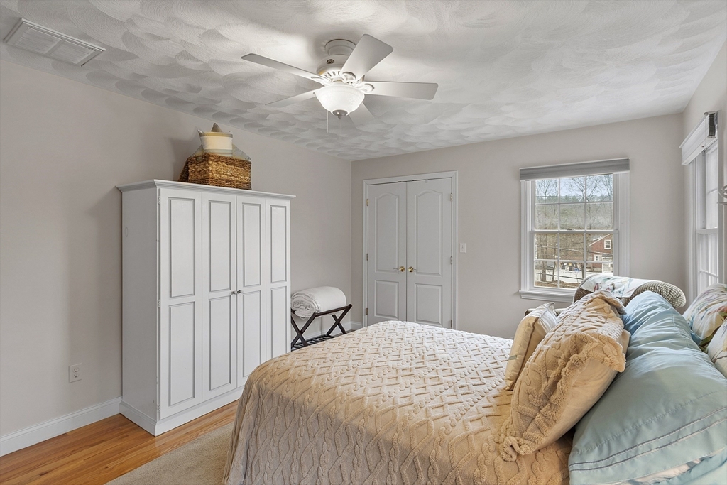 820 Main Street, Unit 1 Wakefield, MA 01880 - Photo 28 of 36 a bedroom with a bed and a window