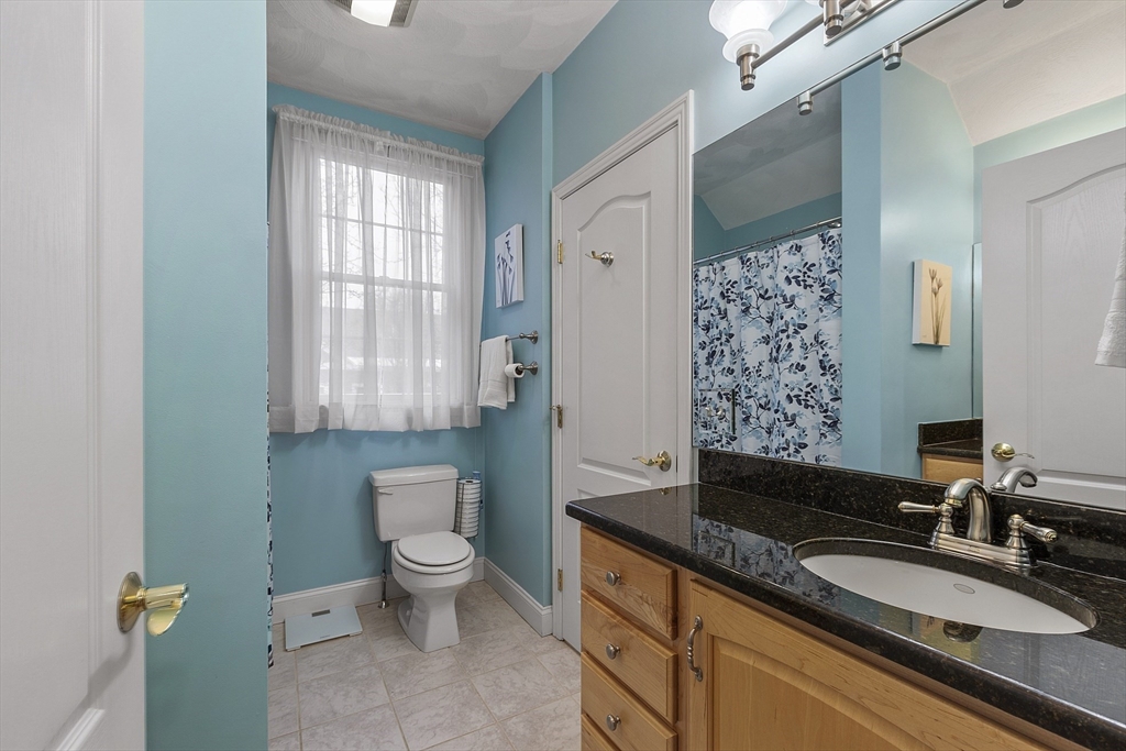 820 Main Street, Unit 1 Wakefield, MA 01880 - Photo 31 of 36 a spacious bathroom with a granite countertop sink a toilet a mirror and shower
