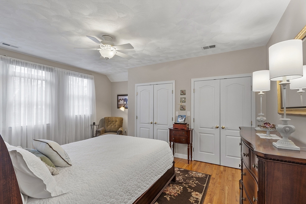 820 Main Street, Unit 1 Wakefield, MA 01880 - Photo 33 of 36 a bedroom with a bed and a chandelier