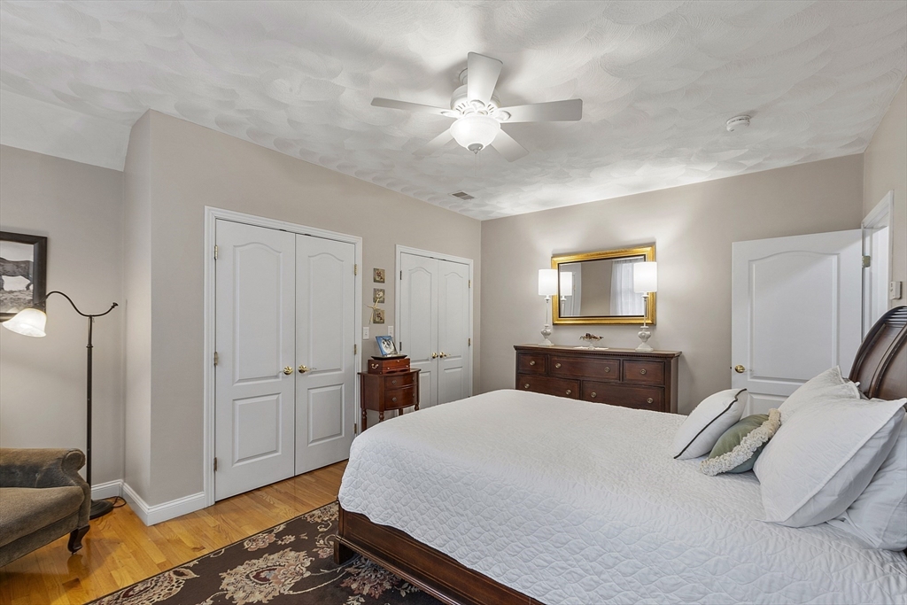 820 Main Street, Unit 1 Wakefield, MA 01880 - Photo 35 of 36 a bedroom with a bed and a chandelier